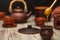 Tea ceremony, tea party. Clay dishes. Honey flows from a wooden