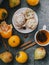 Tea, cinnamon sticks, muffins, pears, star anise and persimmons