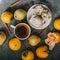 Tea, cinnamon sticks, muffins, pears, star anise and persimmons