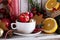 Tea cup with decorations, cookies and oranges for Christmas