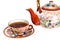 Tea cup filled with tea and teapot of painted Chinese porcelain