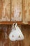 Tea cup hanging on a hook in old wooden cupboard