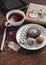 Tea cup with a homemade tea bag, sweets - cake, cookies and homemade candy, homemade Valentine\'s day gift in kraft paper