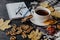 Tea cup near scarf making composition, top view. Cup of tea with slice of lemon put near beautiful leaves. Hot beverage with sugar