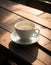 A tea cup is placed on a saucer on a wooden table