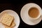 Tea cup and plate with stack of cream cracker biscuits  black background. Top View. Close up picture. Chinese tea cup,