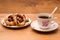 Tea Cup and saucer with donuts.