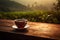 Tea cup with on the wooden table and the tea plantations background. Generative AI