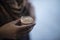 Tea in an earthen pot being hold in a hand 