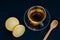 Tea in a glass cup on a plate and cookies on a dark blue table. Top view