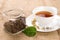 Tea, green leaf and glass coffee jar