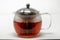 A tea infusing tea pot brewing a cup of tea