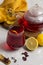 Tea karkade in a glass and leaves of hibiscus, honey and lemon on a white table