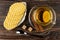 Tea with lemon in cup, cinnamon on saucer, wafers in plate, sugar, teaspoon on table. Top view