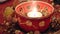 Tea Light burning in ceramic bowl at Christmas