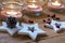 Tea lights in jars with salt, wood stars, pine cone and red berries Christmas, New Year, advent