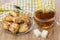 Tea, lumpy sugar, plate with cookies, napkin and teaspoon