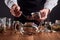 Tea master putting rose buds into a glass teapot