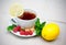 Tea with mint, brown sugar, raspberry and lemon on table