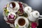 Tea in old porcelain cups, panakota dessert and raspberry on an old silver tray. Retro.