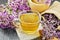 Tea of oregano in cup with mortar on wooden board