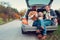 Tea party in car truck - loving couple with dog sits in car truck