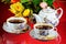 Tea party - tea in cups, teapot, garden flowers on a summer day. Daily tea is a delicious, popular, healthy, invigorating drink