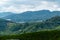 Tea plantations fields on hillside. Landscape view along the mountain that crosses the agriculture farm and rural village