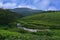 Tea plantations in India. Stunning views of green hills with blue sky.