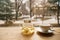 Tea from a sea-buckthorn in a transparent teapot on a wooden table on a window facing the street