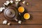 Tea set (teapot, cups and different green tea) a wooden background