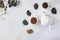 Tea set with white ceramic tea pot and other tea ingredients on the white. Flat lay view of various dried teas and teapot. View