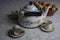 Tea table with, teapot, cups, basket, bread and cookies