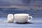 Tea time concept. Cup or white porcelain mug with transparent hot water and bag of tea. Mug filled with boiling water