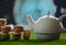 Tea time, oriental tales, teapot with French sweets, macaroons, starry sky and moon. Delicious and spicy tea with sweets, close-up