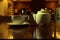 Tea time. White teacup and teapot on the wooden table in dark room, side view
