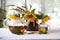 Tea in a transparent teapot and sunflowers in a ceramic vase