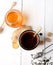 Tea in white metal mug, ginger, sugar and honey on a white background