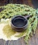 Tea with wormwood in cup on dark board