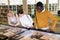 Teacher and adult students view rare books in a library showcase