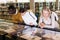 Teacher and adult students view rare books in a library showcase