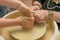 Teacher and apprentice. Revival of folk crafts. Shaping clay on pottery wheel. Creative lesson