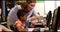 Teacher assisting school kids on personal computer in classroom