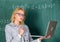 Teacher blonde woman with modern laptop surfing internet chalkboard background. Distance education concept. Lady teacher