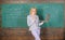 Teacher blonde woman with modern laptop surfing internet chalkboard background. School innovation. Distance education