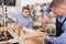 teacher and boy chiselling a wooden bench in workshop