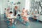 Teacher checking homework of her pupils in class.