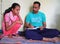 Teacher is checking notebook of his student in Jaipur, India