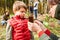 Teacher and daycare child with a seedling at arborology