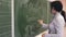 Teacher draws on the blackboard